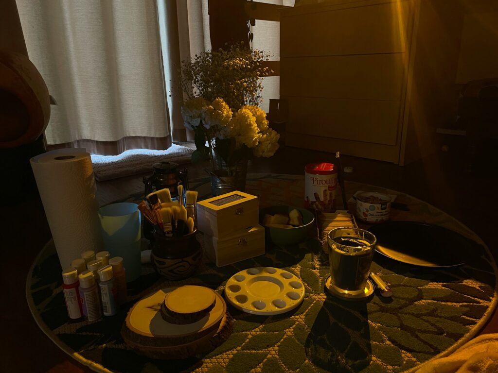 a table with a vase of flowers and other items on it